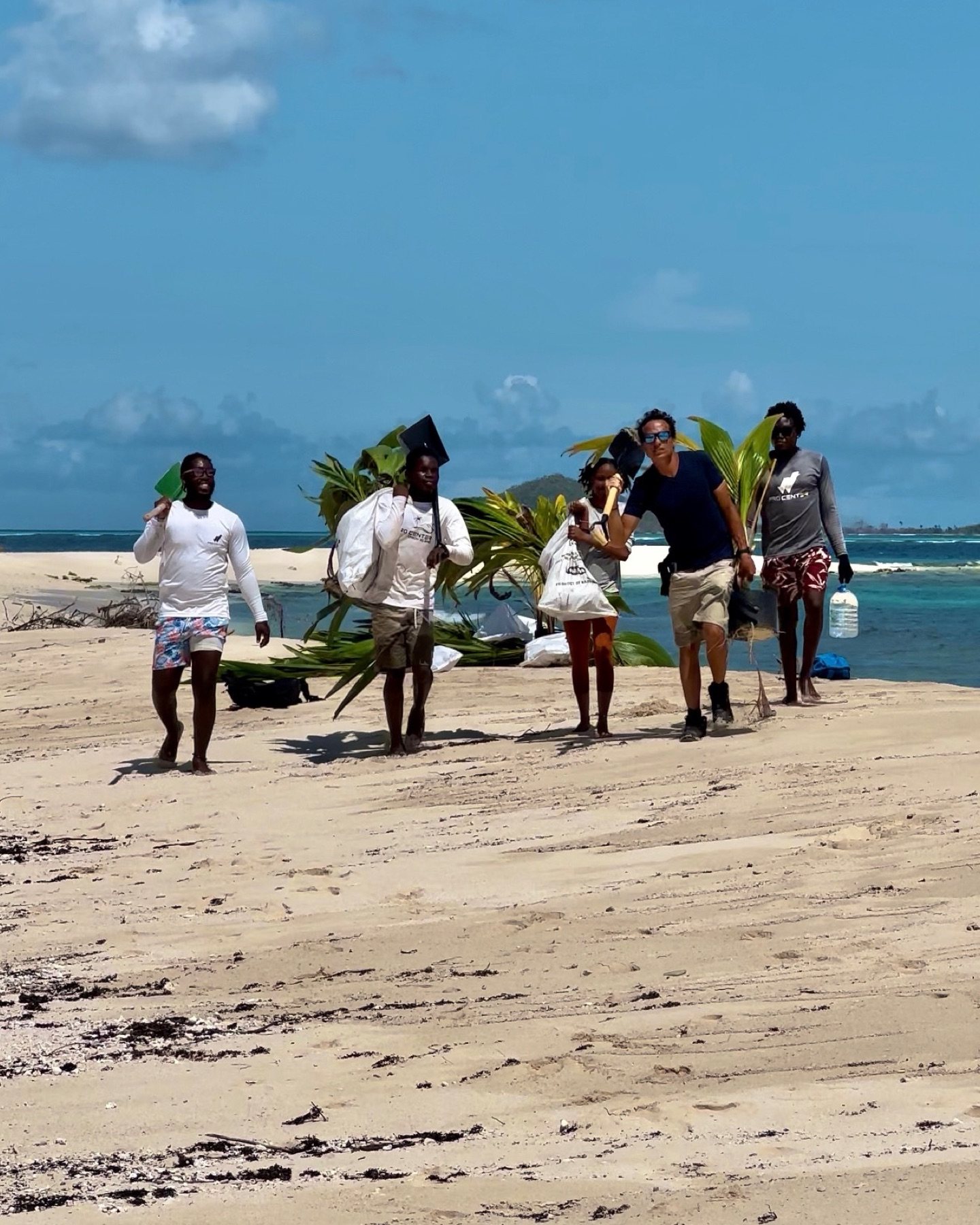 Relief team carrying supplies along the beach