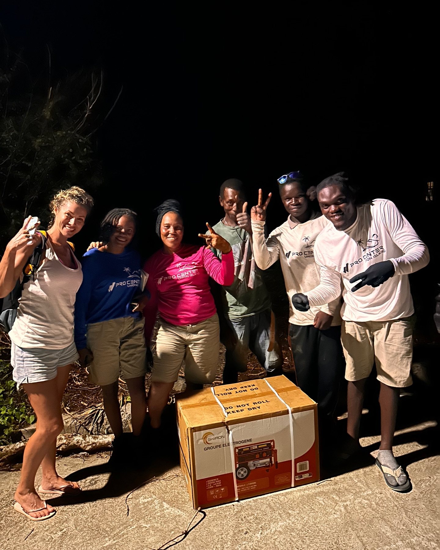 Union Island relief team and residents with a generator